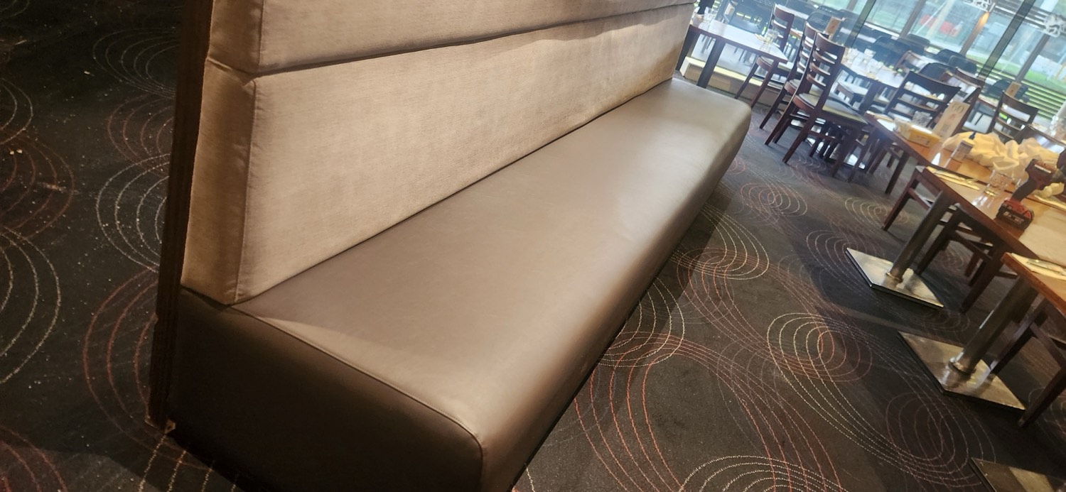 The recovered Veneto Club banquette in new commercial vinyl